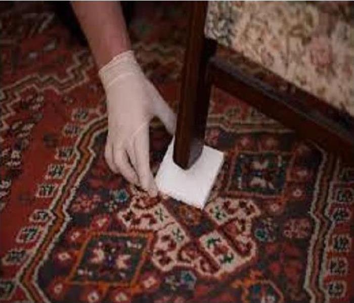 Placing carpet blocks under furniture leg