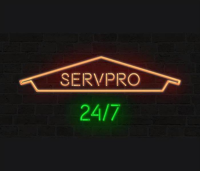 SERVPRO 24/7 Neon sign on black background